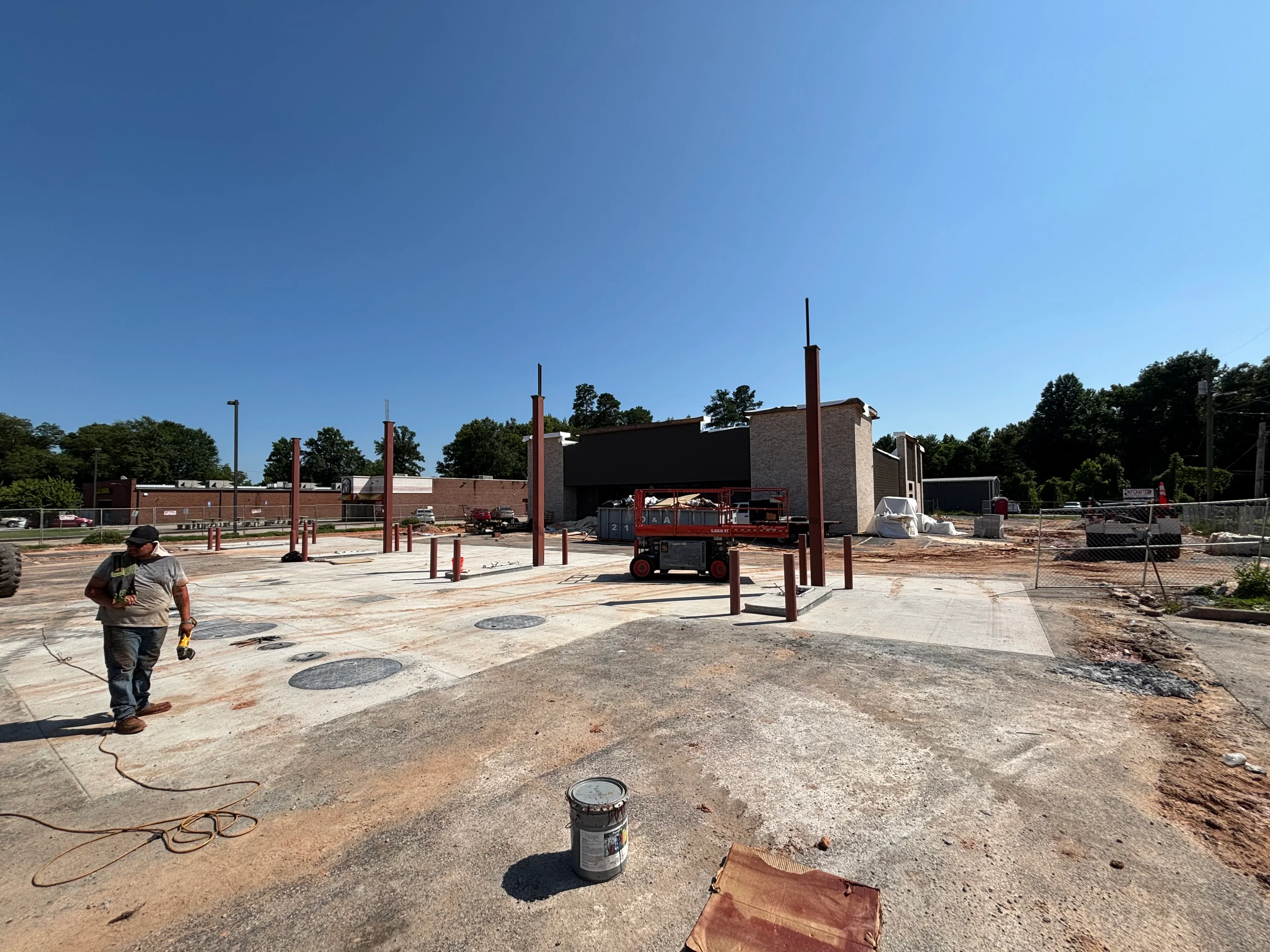 Steel support columns and structural framework installed on concrete foundation during construction